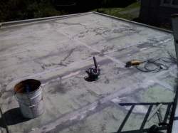 entire roof is sanded, to level off epoxy and roughen surface for new coating