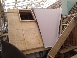first sheet of TPO cut to shape and glued to 45 degree roof