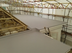 view across completed back roof to main level 2 roof