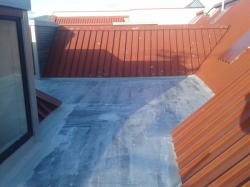 more hydroepoxy priming, on the L shaped roof, view upslope from the front entry